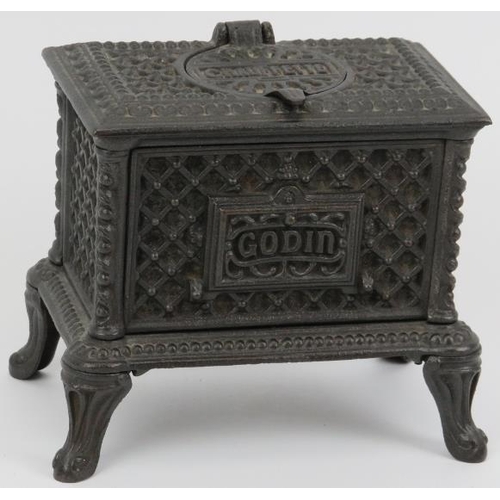 70 - A miniature novelty cast iron inkwell modelled as a Godin ‘Chauffette’ stove, 20th century. The exte... 