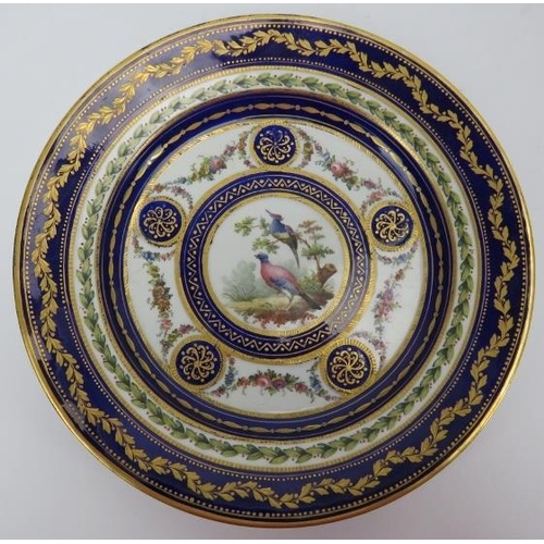 74 - A French Sèvres gilt and polychrome enamelled porcelain cabinet plate, mid 18th century. Hand gilt a... 