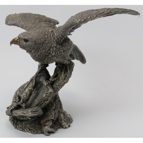 78 - A naturalistically modelled silver eagle, late 20th century. Modelled with wings spread on a rocky o... 