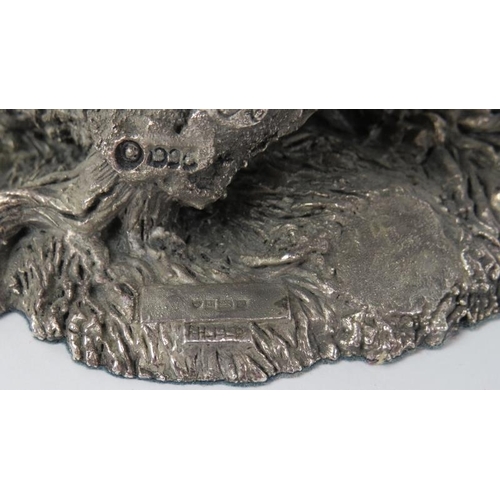 78 - A naturalistically modelled silver eagle, late 20th century. Modelled with wings spread on a rocky o... 