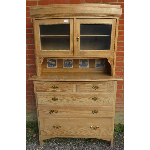 701 - A 19th century stripped pine bowfront cabinet on chest, having two glazed panelled doors above reces... 