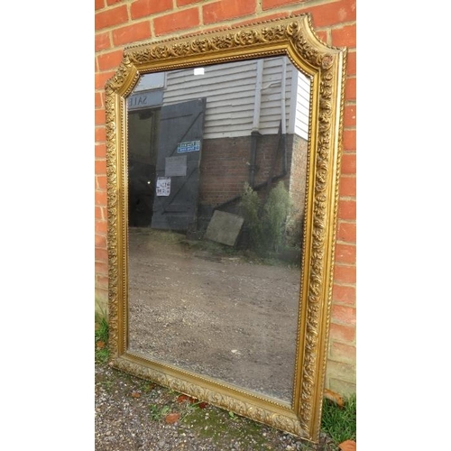 703 - A large 19th century French giltwood wall mirror, of rectangular form with swept inverted top corner... 