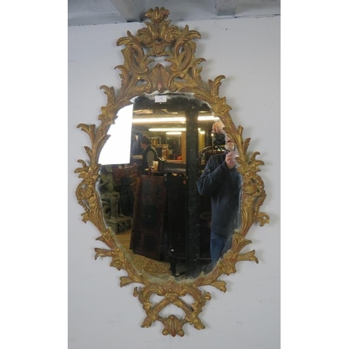 706 - A highly decorative Georgian revival carved giltwood wall mirror, 20th century, decorated with scrol... 