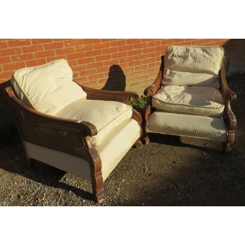 707 - A pair of early/mid 20th century Bergere armchairs, having ornately carved show-wood frames, double-... 