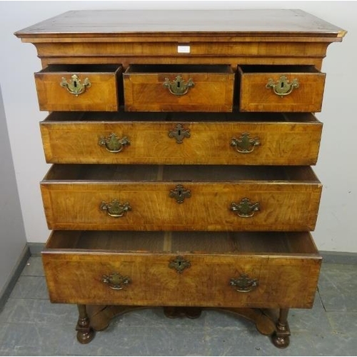 711 - An antique cross-banded walnut chest on stand in the Queen Anne style, the swept moulded cornice abo... 