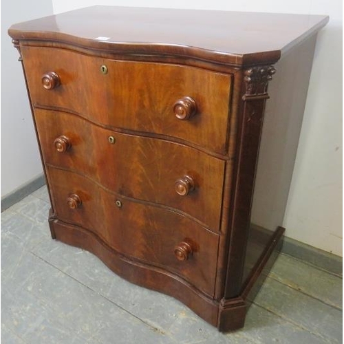 712 - A 19th century serpentine fronted feathered mahogany chest of three long graduated drawers, turned k... 