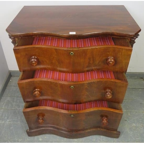 712 - A 19th century serpentine fronted feathered mahogany chest of three long graduated drawers, turned k... 