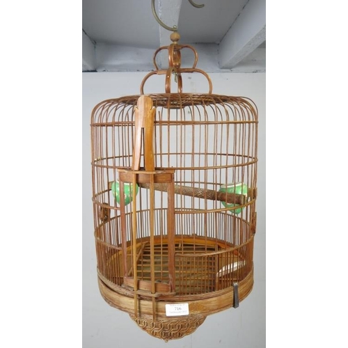 716 - An Asian bamboo bird cage of decorative period design, 20th century.
H56cm (approx).