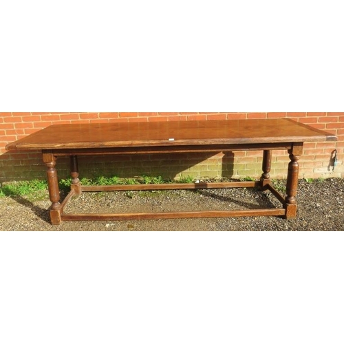 720 - A large oak refectory table in the 17th century taste, on turned and block supports joined by stretc... 