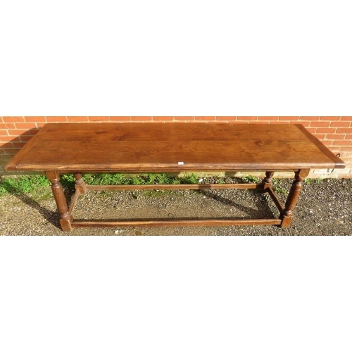 720 - A large oak refectory table in the 17th century taste, on turned and block supports joined by stretc... 