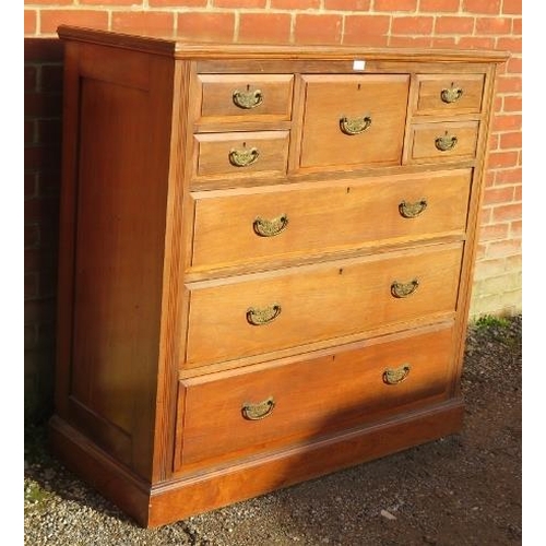 722 - A turn of the century walnut bedroom chest, the central hat drawer flanked by four short drawers, ab... 