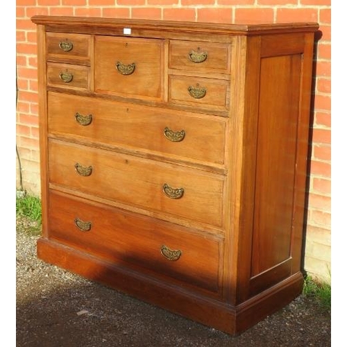 722 - A turn of the century walnut bedroom chest, the central hat drawer flanked by four short drawers, ab... 