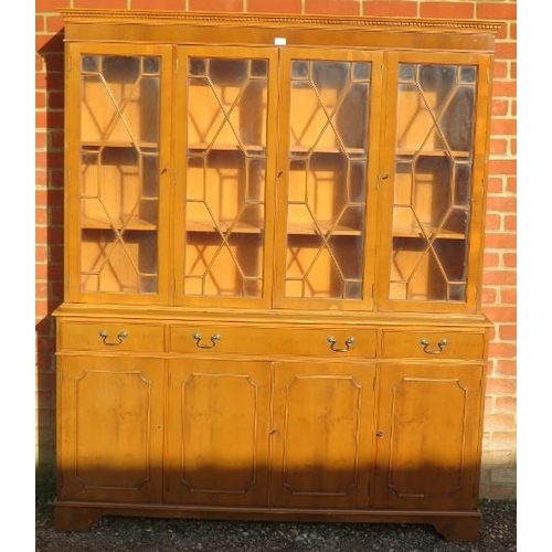 723 - A reproduction yew wood library bookcase, having a dentil cornice above four astral glazed doors, ho... 