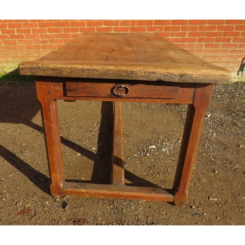 728 - A 19th century rustic French farmhouse kitchen table of good patina, having a side drawer and an end... 