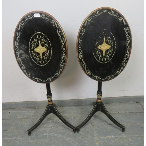 729 - A pair of French Empire style ebonised oval tilt-top tables, hand-painted with Classical motifs and ... 