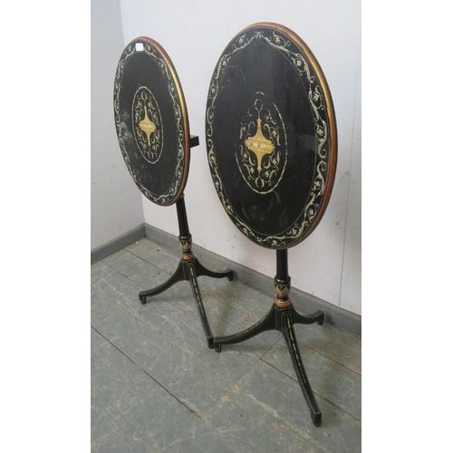 729 - A pair of French Empire style ebonised oval tilt-top tables, hand-painted with Classical motifs and ... 