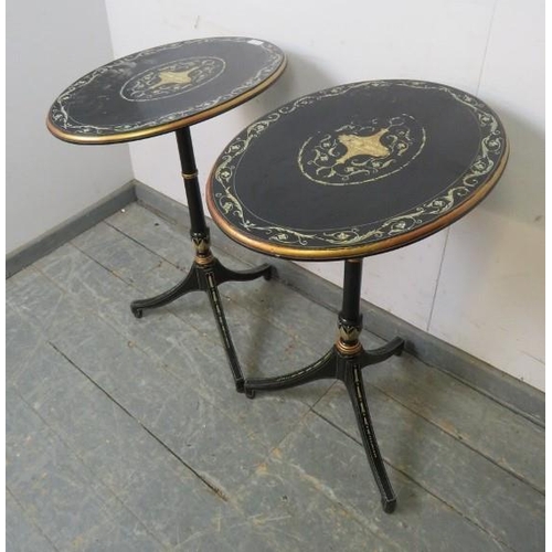 729 - A pair of French Empire style ebonised oval tilt-top tables, hand-painted with Classical motifs and ... 