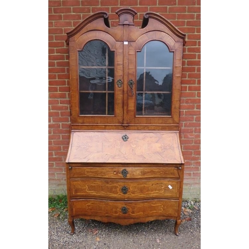 730 - A large 18th century Continental marquetry bureau bookcase, having a broken and scrolled pediment ab... 