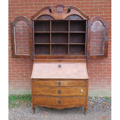 730 - A large 18th century Continental marquetry bureau bookcase, having a broken and scrolled pediment ab... 