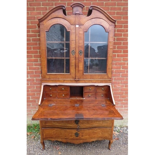 730 - A large 18th century Continental marquetry bureau bookcase, having a broken and scrolled pediment ab... 