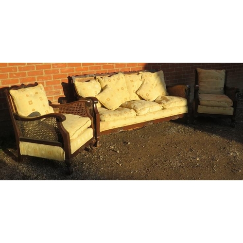 733 - A vintage early/mid 20th century Bergere three piece lounge suite, comprising a three seater settee,... 