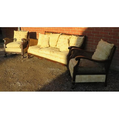 733 - A vintage early/mid 20th century Bergere three piece lounge suite, comprising a three seater settee,... 