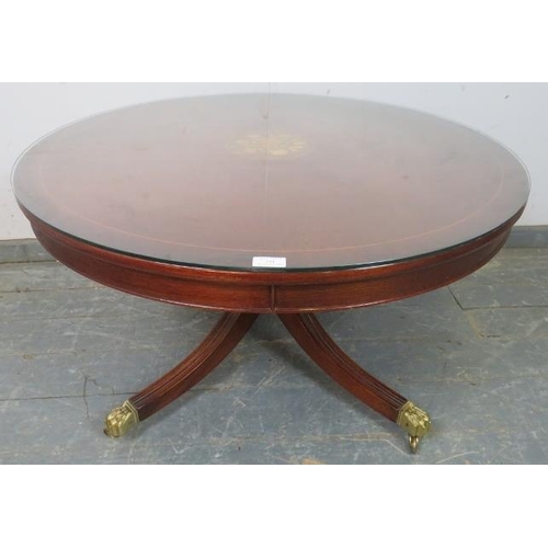 741 - A reproduction mahogany circular coffee table, crossbanded and having central marquetry inlaid panel... 