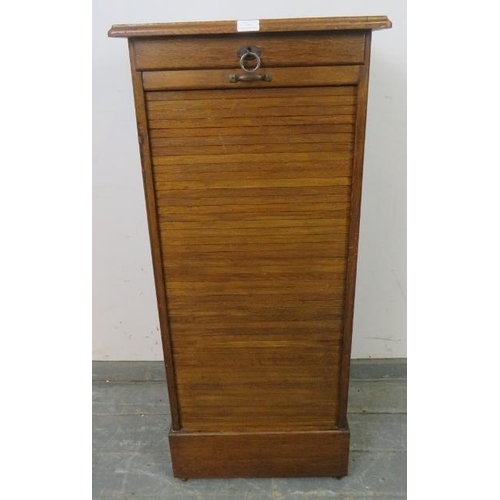 754 - An early 20th century oak tambour front pedestal cabinet, containing drawers, with key, pedestal bas... 