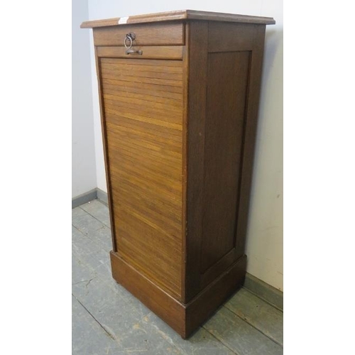 754 - An early 20th century oak tambour front pedestal cabinet, containing drawers, with key, pedestal bas... 