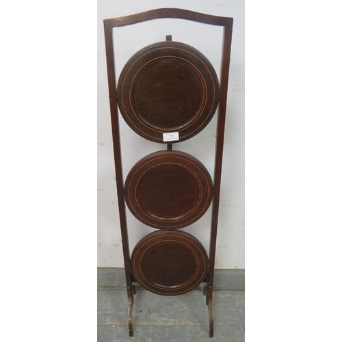 757 - An Edwardian boxwood strung mahogany three tier cake stand.
H90cm (approx).