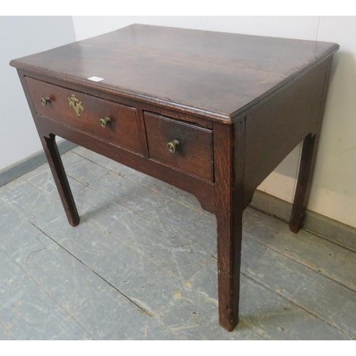 763 - An 18th century oak lowboy with one long drawer, raised on inner chamfered legs, some repairs and re... 