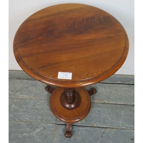 770 - A Victorian mahogany circular lamp table, supported on a baluster turned column having a basket with... 