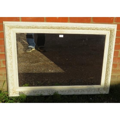 774 - A reproduction period-style cream finished wall mirror, relief marbled decoration and bevelled plate... 