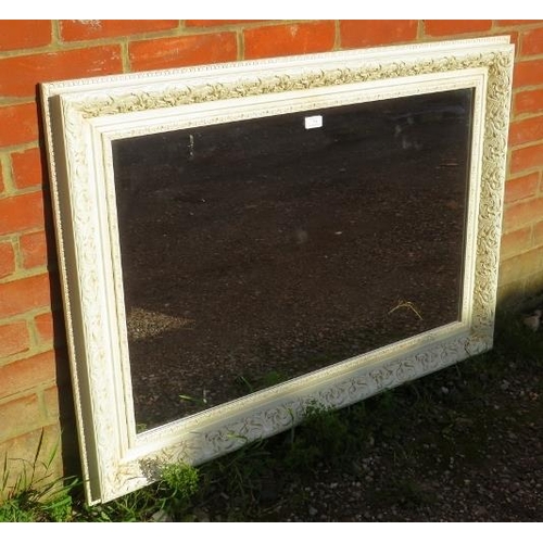 774 - A reproduction period-style cream finished wall mirror, relief marbled decoration and bevelled plate... 