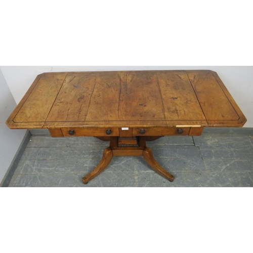 777 - An English Regency Period mahogany sofa table inlaid with ebony stringing, faded patination, two dra... 