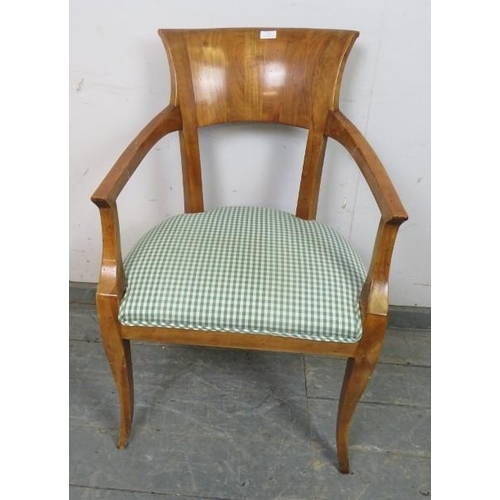 787 - An Empire style fruitwood open-sided armchair, upholstered seat.