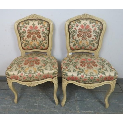 791 - A pair of vintage French side chairs in the Louis XV style, cream painted carved wood frames, classi... 