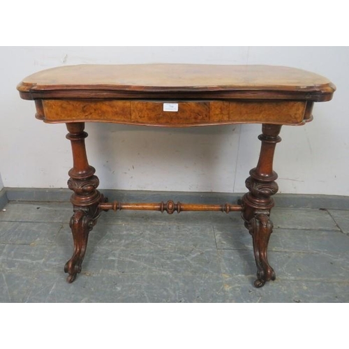 794 - A Victorian figural walnut card table, the serpentine rectangular top with inverted rounded corners,... 