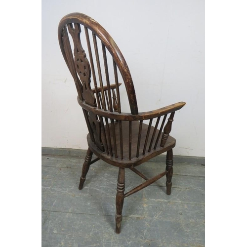 796 - An early 20th century elm & beech wheel-back Windsor armchair.