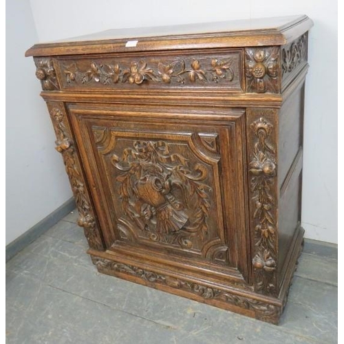 803 - A 19th century carved oak side cupboard in the Flemish taste, one long frieze drawer above cupboard ... 