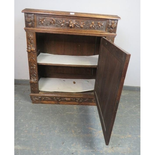 803 - A 19th century carved oak side cupboard in the Flemish taste, one long frieze drawer above cupboard ... 