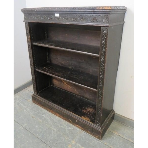 812 - A 19th century carved oak open-front low bookcase in the Flemish taste, 2 adjustable shelves, plinth... 