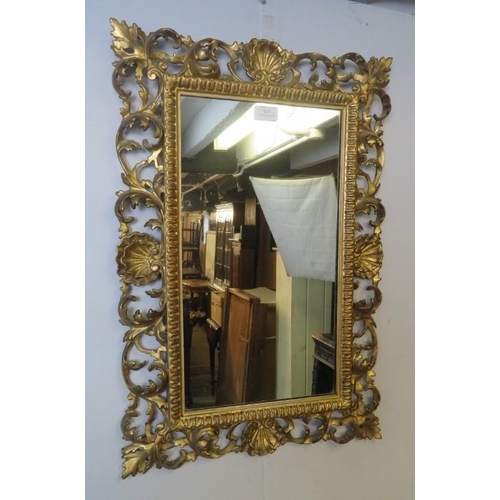 813 - A good late 19th/early 20th century Florentine carved giltwood wall mirror, with intricate scrolling... 