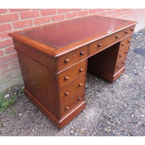 816 - A 19th century walnut pedestal desk, having inset gilt tooled burgundy leather surface, housing a co... 