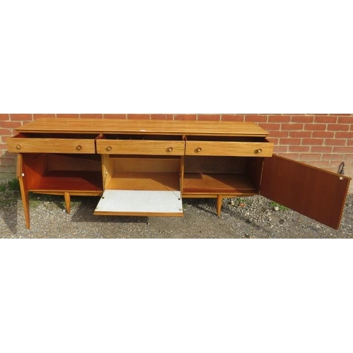 821 - A mid-century ash sideboard, housing three short drawers with turned wooden handles, above a fall fr... 