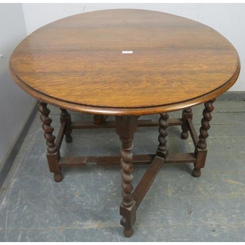 828 - An antique oak oval gate-leg table of small proportions, on barley twist supports with stretchers. 
... 