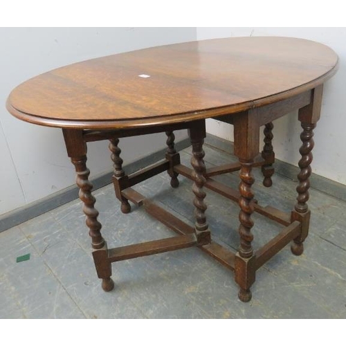 828 - An antique oak oval gate-leg table of small proportions, on barley twist supports with stretchers. 
... 