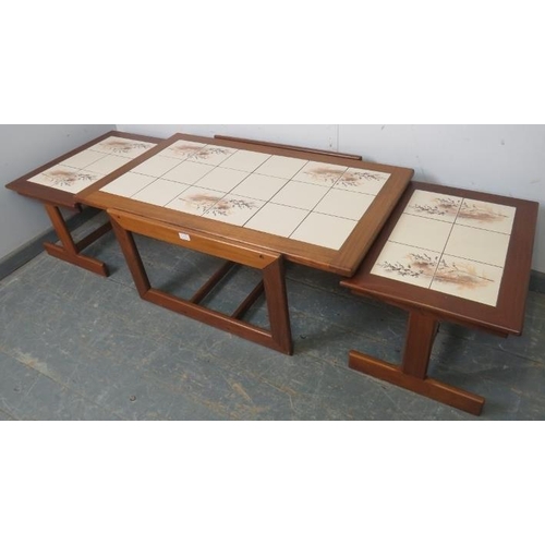 830 - A vintage mid-century set of three tile-topped nesting tables by Keith Eatwell, comprising a rectang... 