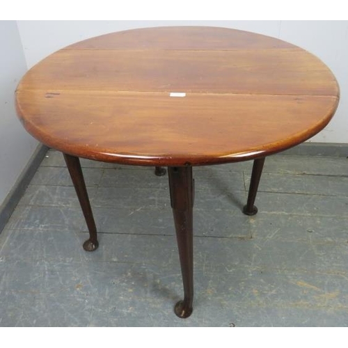 833 - A George III mahogany oval drop-leaf cottage dining table, raised on pad feet supports, 91cm wide op... 