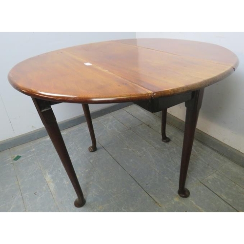 833 - A George III mahogany oval drop-leaf cottage dining table, raised on pad feet supports, 91cm wide op... 